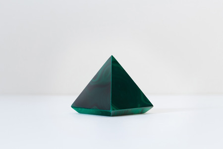 Green malachite gemstone polished with a pyramid formの写真素材