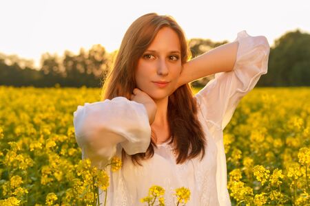 Young caucasian woman is posing in the fieldの写真素材
