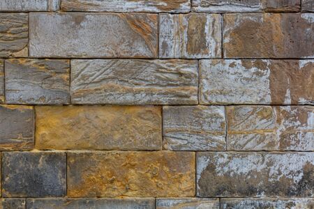 Masonry wall of old stone blocks. Background texture of a old wallの写真素材