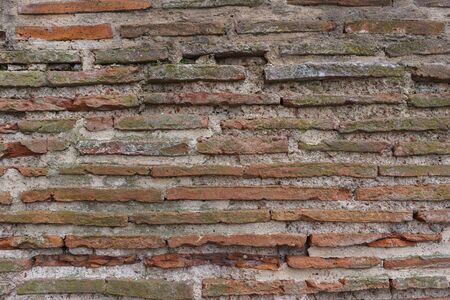 Old brick wall with cracks and scratches. Horizontal wide brickwall backgroundの写真素材