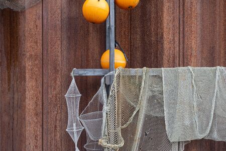 Drying old holey fishing net. Maritime nautical background texture.の写真素材