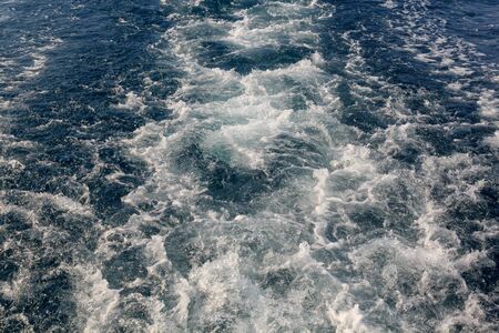 Surface of the water behind a fast moving shipの写真素材