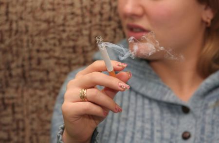 Woman smokes and spoil your health, do not smoke is bad! の写真素材