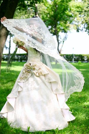 Bride for a walk in the park playing with a young bride の写真素材