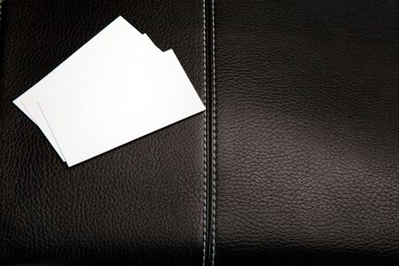 Business cards on a leather briefcase. Isolated on white. の写真素材