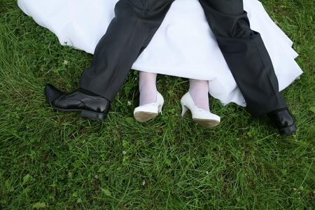 Wedding newlyweds walk ended with kisses on the grassの写真素材