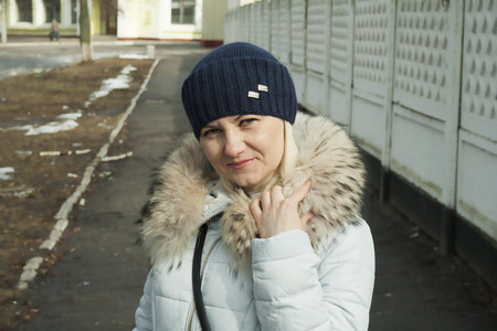 Beautiful middle-aged woman on the street in winterの写真素材