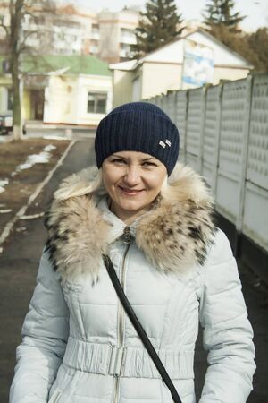 Beautiful middle-aged woman on the street in winterの写真素材