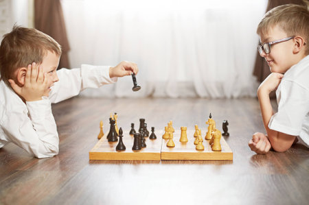 Two serious boy playing chess, studio, backgroundの写真素材