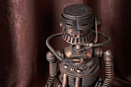 old mechanical robot on a brown backgroundの写真素材