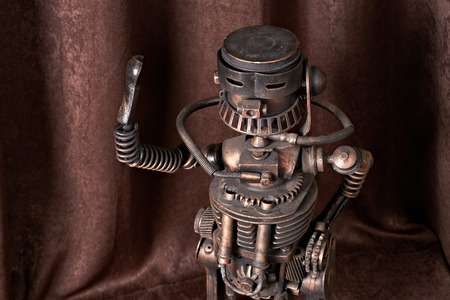 old mechanical robot on a brown backgroundの写真素材