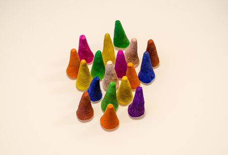 A group of aromatic cones for incense stands on a light surface. Aromatherapy theme backgroundの写真素材