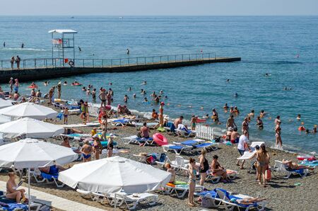 Sochi, Russia - July 20, 2019: Tourists bathe and sunbathe on the beachのeditorial素材