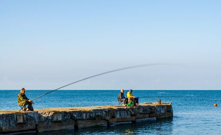 Sochi, Russia - July 20, 2019: Fish in the early morning catch fish in the breakwaterのeditorial素材
