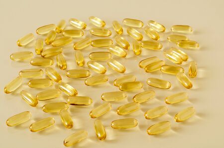 Scattering Omega 3 capsule on a glass tableの写真素材