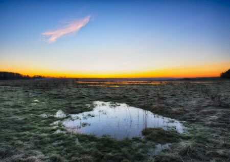 spring morning. a picturesque dawn by the riverの写真素材
