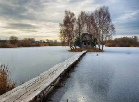 House on the island. Bridge on a river to a picturesque hutの写真素材