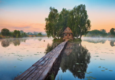 small house on the island. bridge on a picturesque lake. nature of Ukraineの写真素材