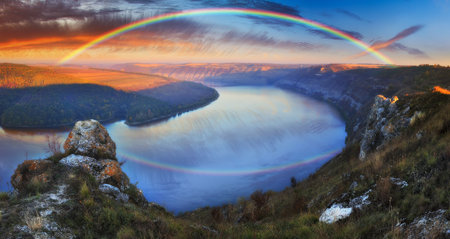 colorful rainbow over river canyon. autumn landscape. nature of Ukraineの写真素材