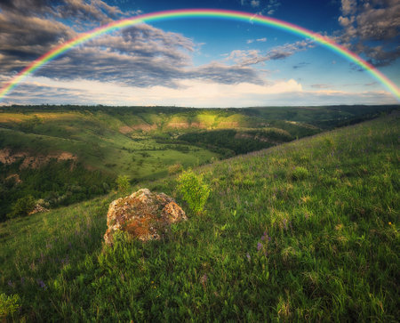 Beautiful landscape with a rainbow in the sky. spring landscapeの写真素材