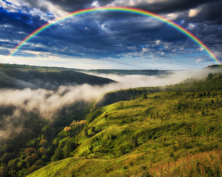 Beautiful landscape with a rainbow in the sky. spring landscapeの写真素材