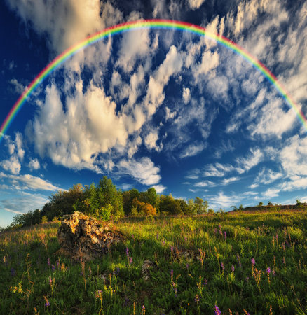 Beautiful landscape with a rainbow in the sky. spring landscapeの写真素材