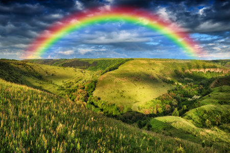 Beautiful landscape with a rainbow in the sky. spring landscapeの写真素材