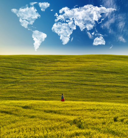 clouds in the form of a map of the world over a hilly field. tourist enjoy breathtaking scenery. Travel and landscape conceptの写真素材