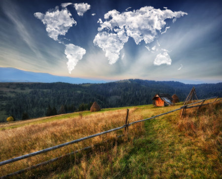 clouds in the form of a map of the world over the mountains. autumn dawn in the Carpathians. Travel and landscape conceptの写真素材