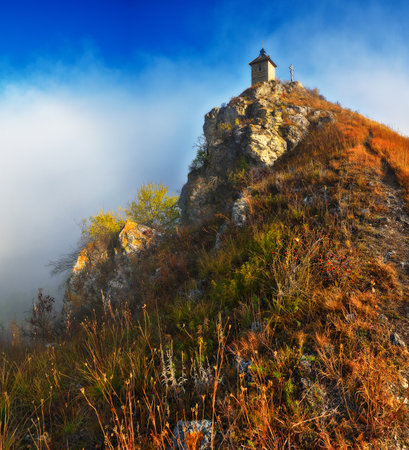 Church on the rock. Autumn landscape with fog. Nature of Ukraineの写真素材