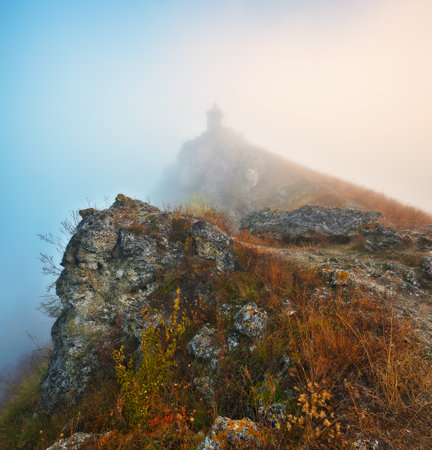 Church on the rock. Autumn landscape with fog. Nature of Ukraineの写真素材