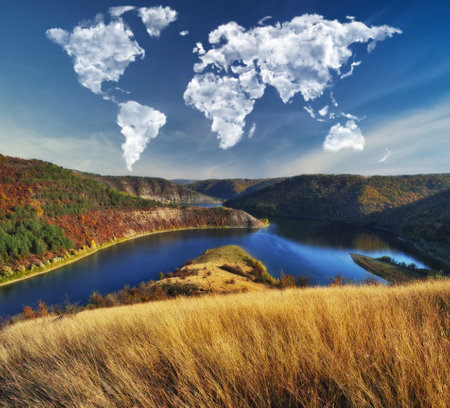 clouds in the form of a world map over the river canyon. Travel and landscape concept. autumn morningの写真素材
