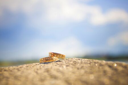 two wedding rings on a stone
