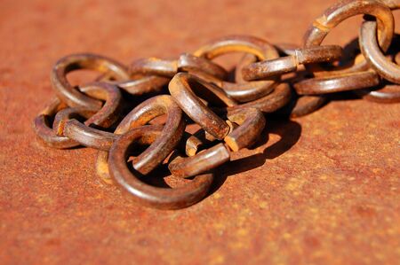 chain lies on a rusty metal
