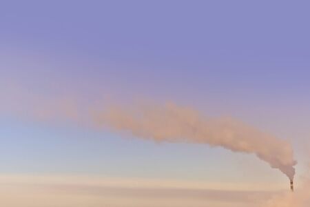 Industrial smoke stack at a power plant on a background of clear sky dayの写真素材