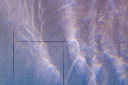 Abstract blue pattern of wave reflection on the water tiles