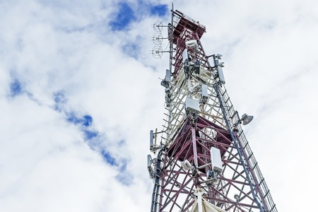 Telecommunication mast TV antennas with blue sky in the morningの写真素材