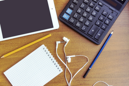 Light wooden Background and modern Business Items Notepad Earphonesの写真素材