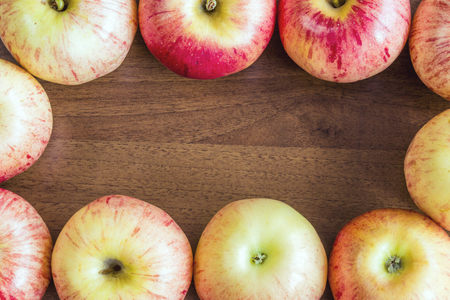 Ripe red apples on wooden backgroundの写真素材