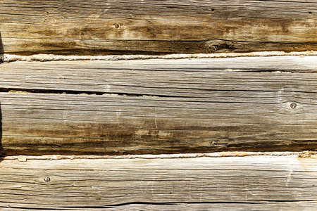 Wooden logs wall of old rural house as backgroundの写真素材