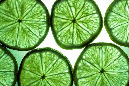 Macro shot of a slice of lime in transmitted lightの写真素材