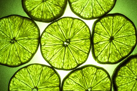 Macro shot of a slice of lime in transmitted lightの写真素材