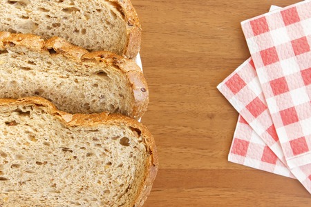 Black bread on table with red napkinsの写真素材