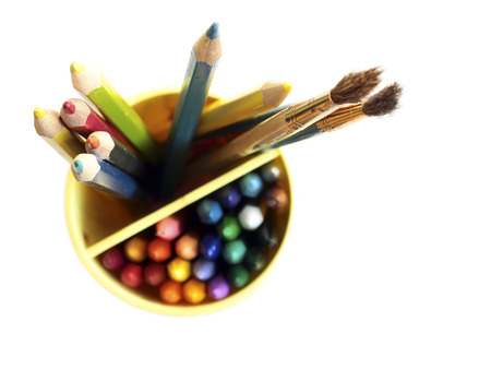 Colored pencils and brushes on a white backgroundの写真素材