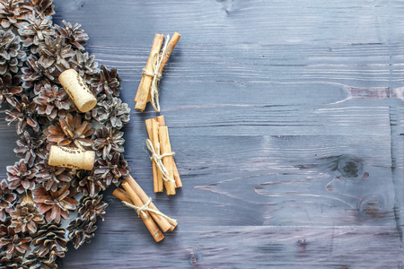 Cinnamon sticks and cork from wine on a wooden backgroundの写真素材
