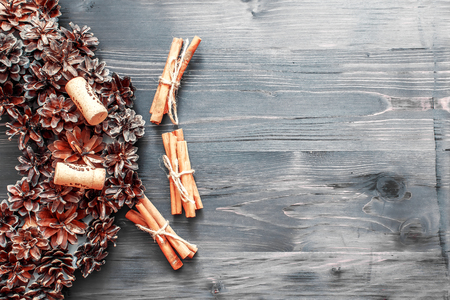 Cinnamon sticks and cork from wine on a wooden backgroundの写真素材