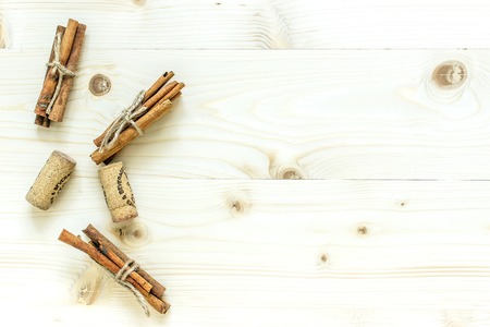 Cinnamon sticks and cork from wine on a wooden backgroundの写真素材