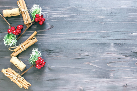 Cinnamon sticks and cork from wine on a wooden backgroundの写真素材