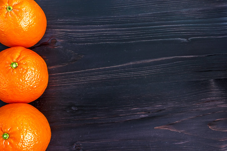 Tangerines on old wooden background.の写真素材