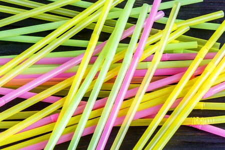 Colorful drinking straws on a wooden backgroundの写真素材